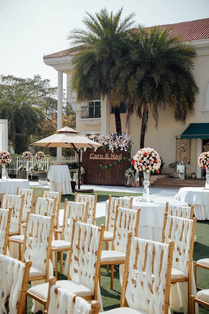 hero-img-02 An elegant outdoor wedding setup with chairs, flowers, and decorations.